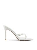 Donatella 100 in Patent White, side profile view showing the open pointed toe, criss-cross straps, and 3.93-inch self-covered stiletto heel