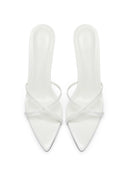Top-down view of a pair of Donatella 100 in Patent White, showing the criss-cross strap design and pointed toe
