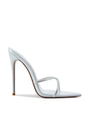 Donatella Mule in Patent White, side profile view showing the open pointed toe, criss-cross straps, and 4.75-inch self-covered stiletto heel