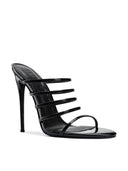 Kalós Slipper in Patent Black - side profile view showing the slim parallel straps and self-covered stiletto heel
